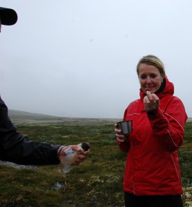 One of the tourists, Heidi, getting her piece of muskox sausage